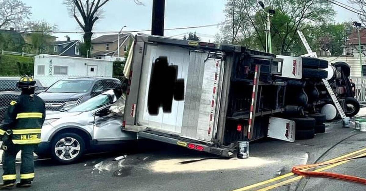 Two Injured After Truck Overturns on Car in Hillside